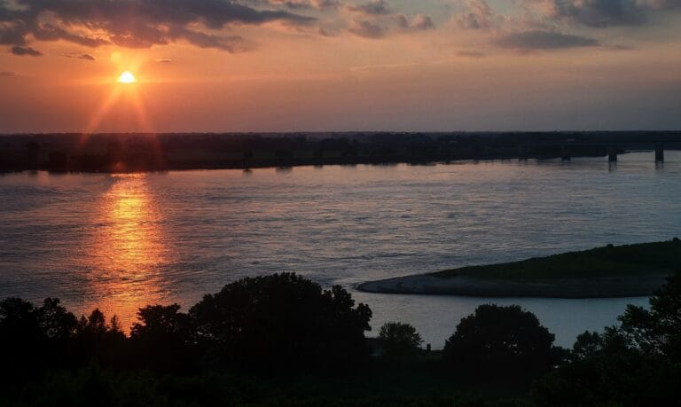 Sunset over the Mississippi River, calm water and warm light, representing a fear with no explanation